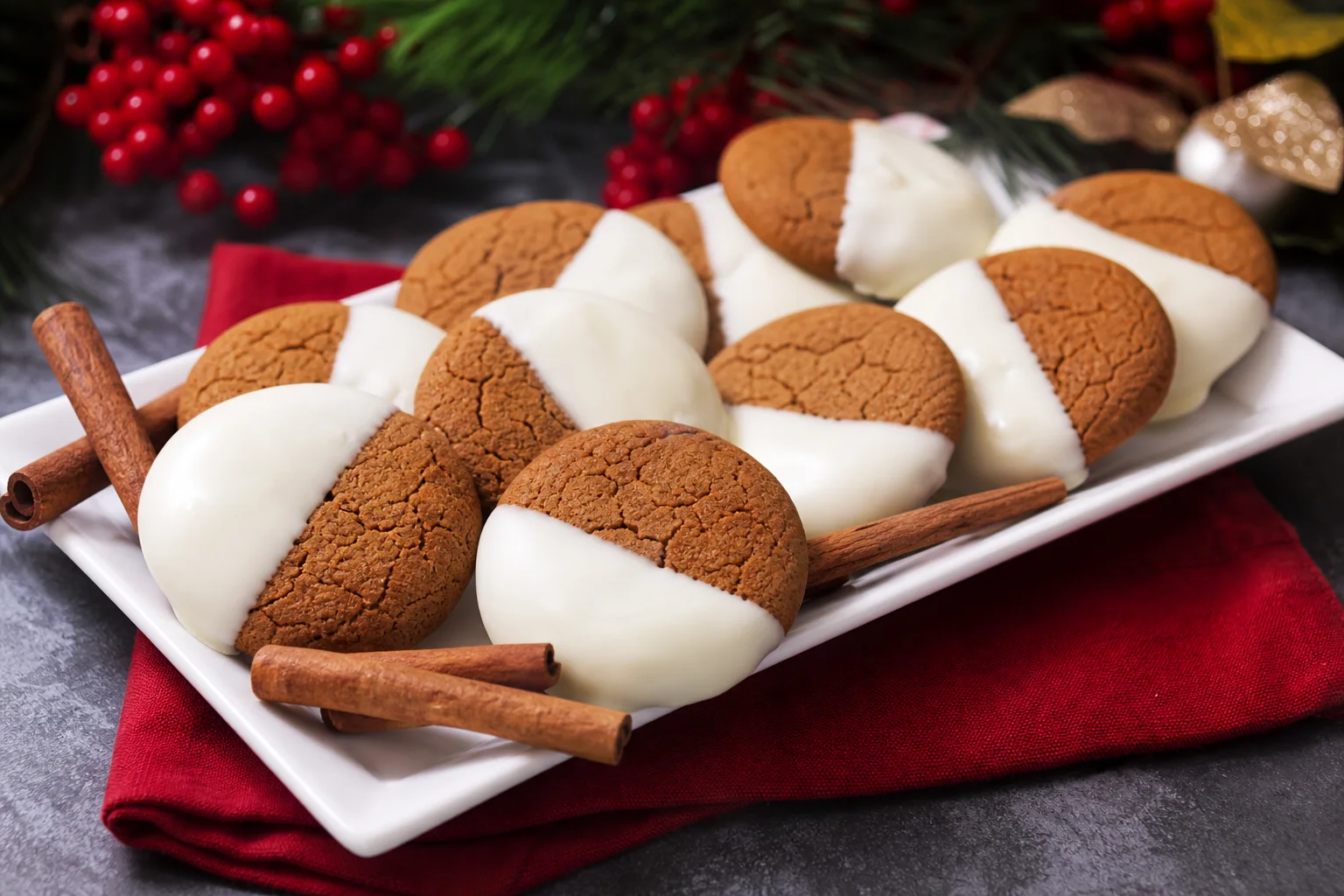White chocolate dipped ginger cookies arranged on a holiday serving platter