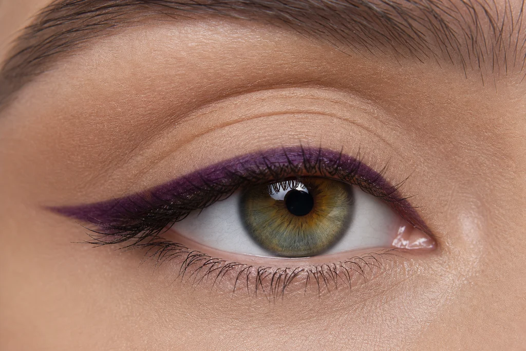 Nude lid with bold plum purple eyeliner on hazel eyes