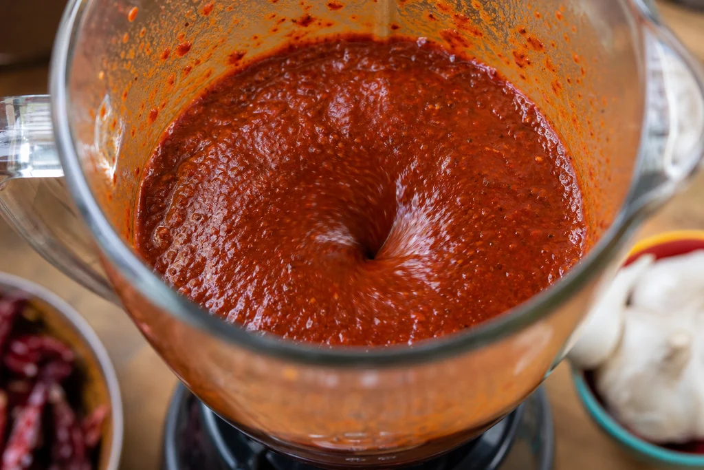 Blending guajillo and ancho chiles into smooth birria adobo paste