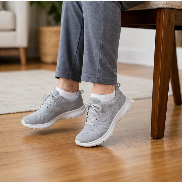 Senior adult doing seated ankle circles and heel-toe taps beside a sturdy chair