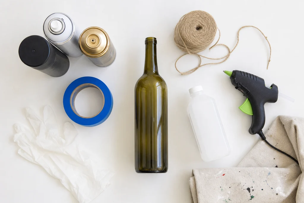 Spray paint painters tape twine and supplies for wine bottle vase DIY
