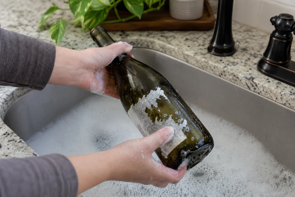Washing and cleaning a wine bottle to remove labels before painting