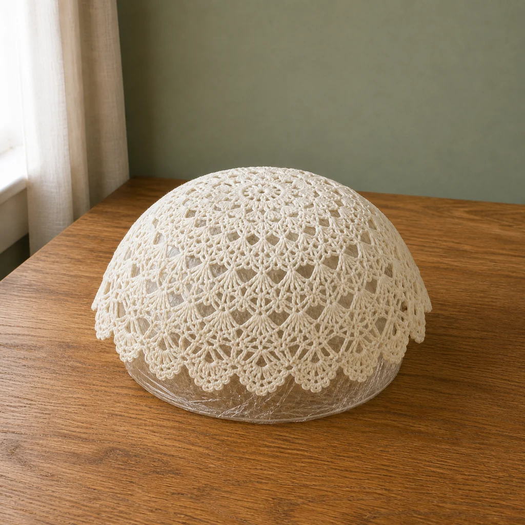 Stiffened lace doily drying evenly on a bowl mold